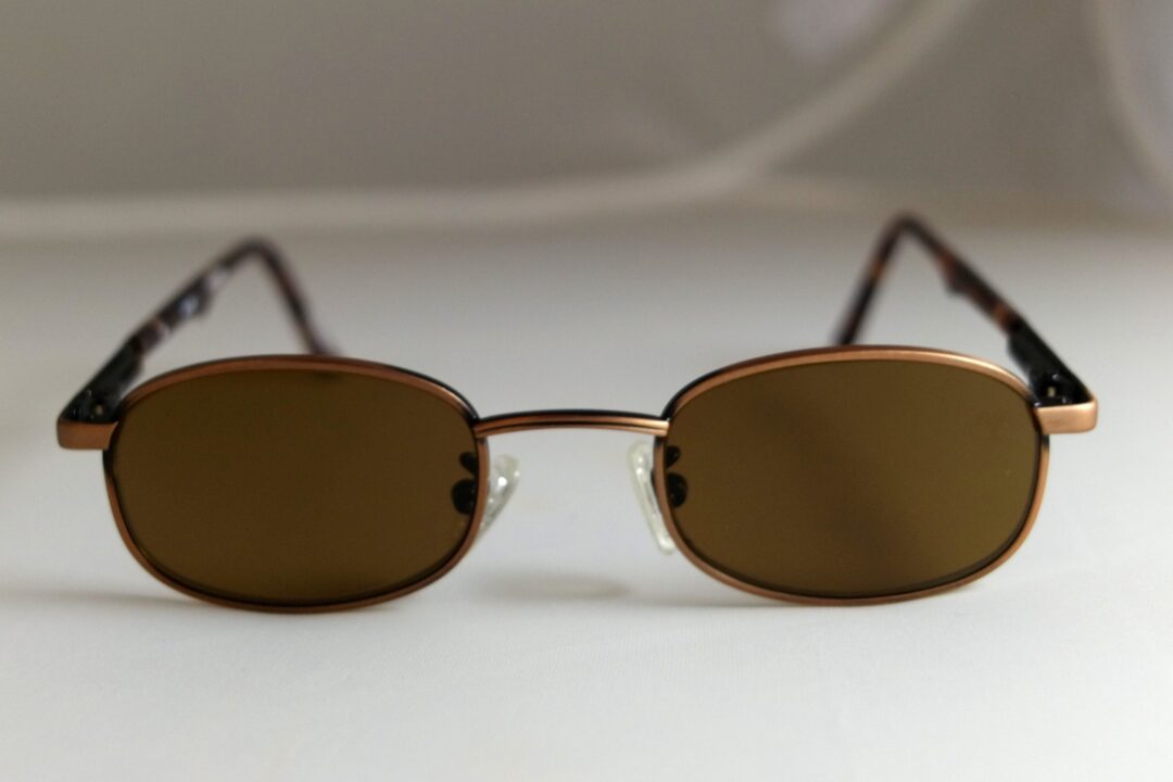 Brown sunglasses on white surface