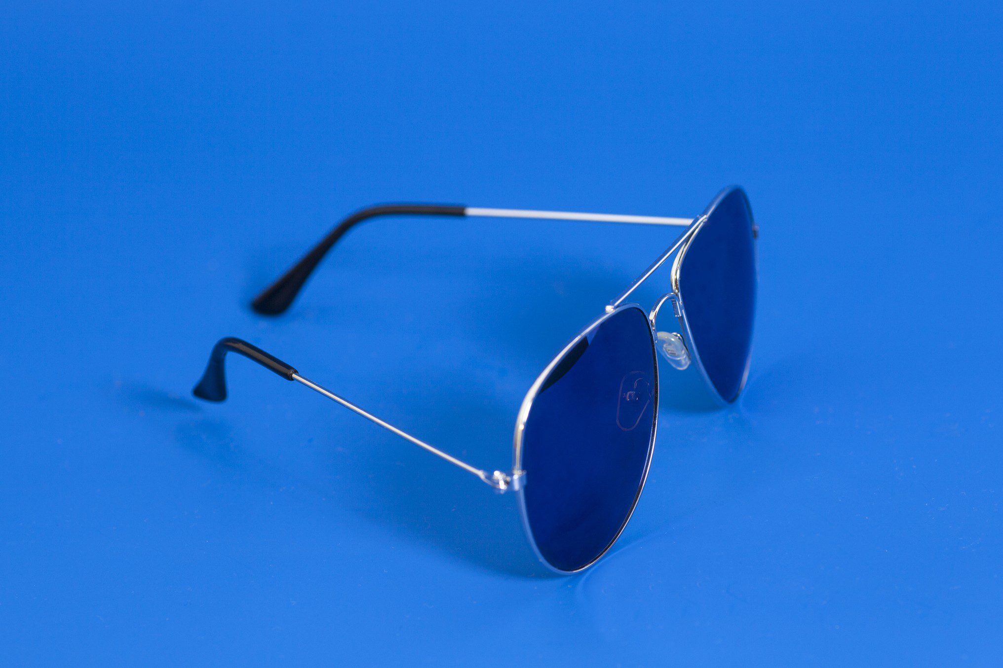 Aviator sunglasses on blue background
