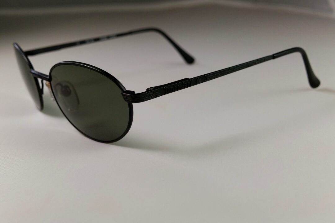 Black sunglasses on a white surface