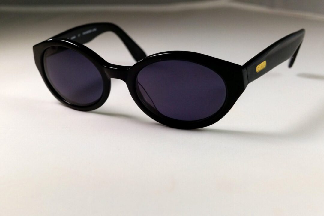 Black sunglasses on white surface
