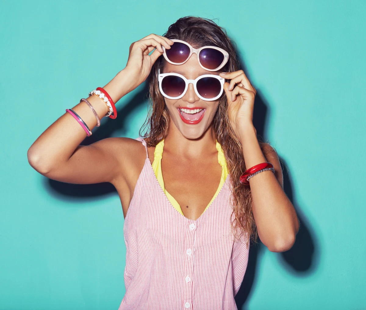 Happy woman wearing layered sunglasses